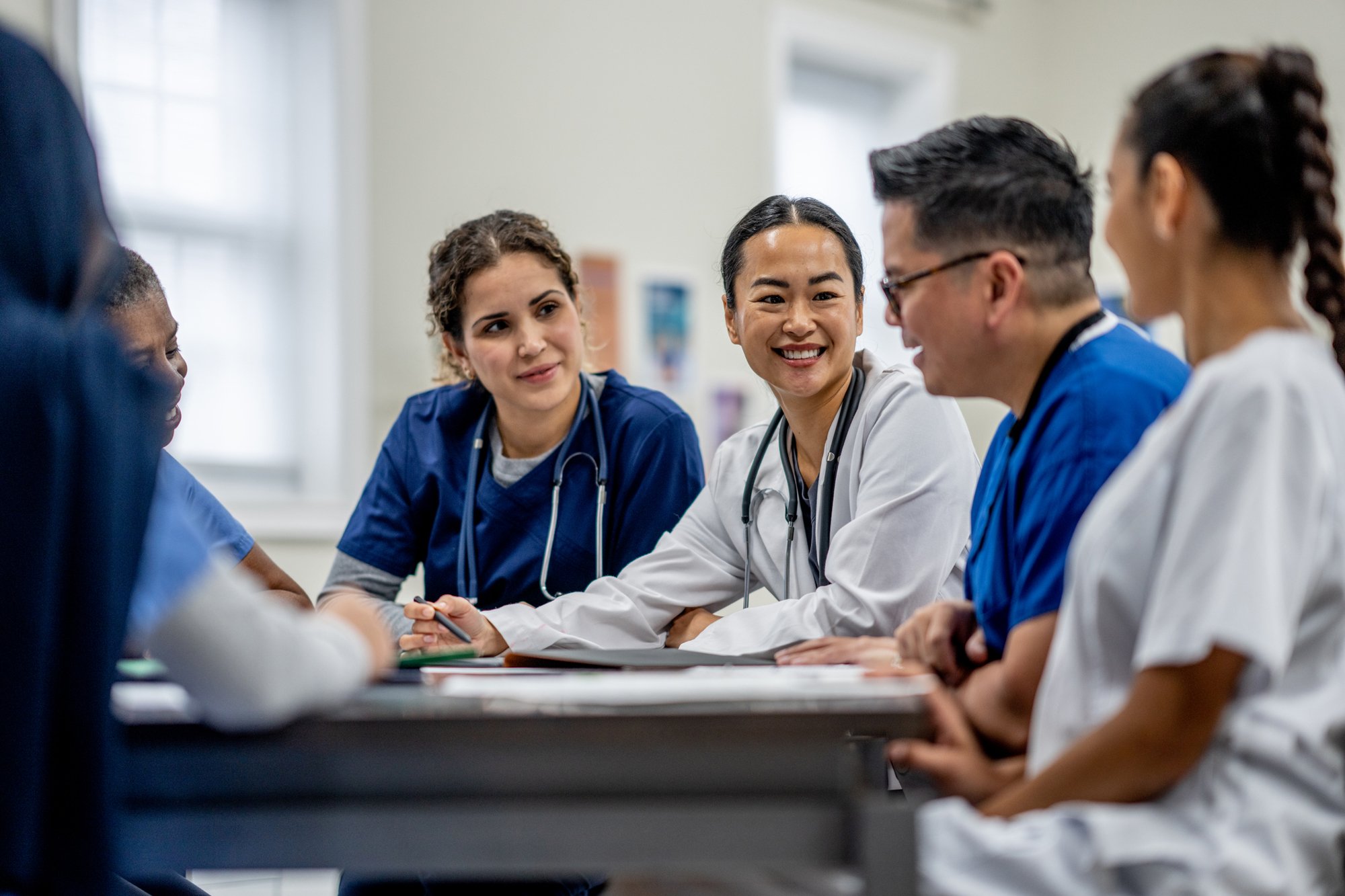 Doctors talking around a table
